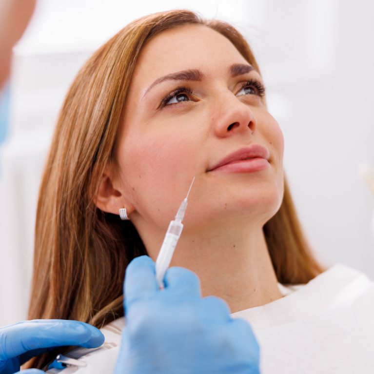 Doctor applying hyaluron fillers to patient