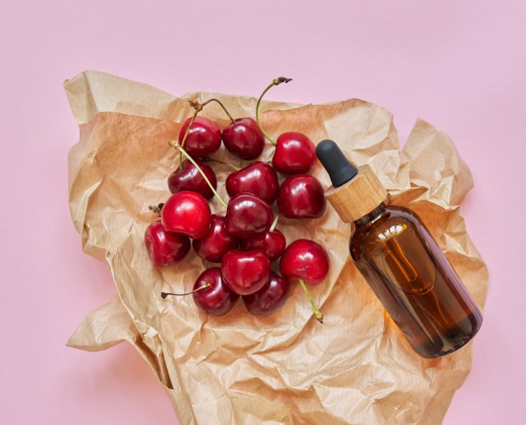 Natural healthy organic cosmetics, fruits, cherries, bottle with cosmetic product