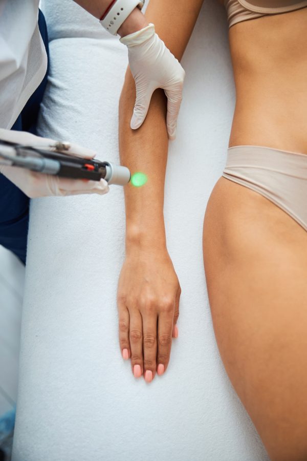 Woman undergoing a laser epilation in a beauty parlor Woman undergoing a laser epilation in a beauty parlor